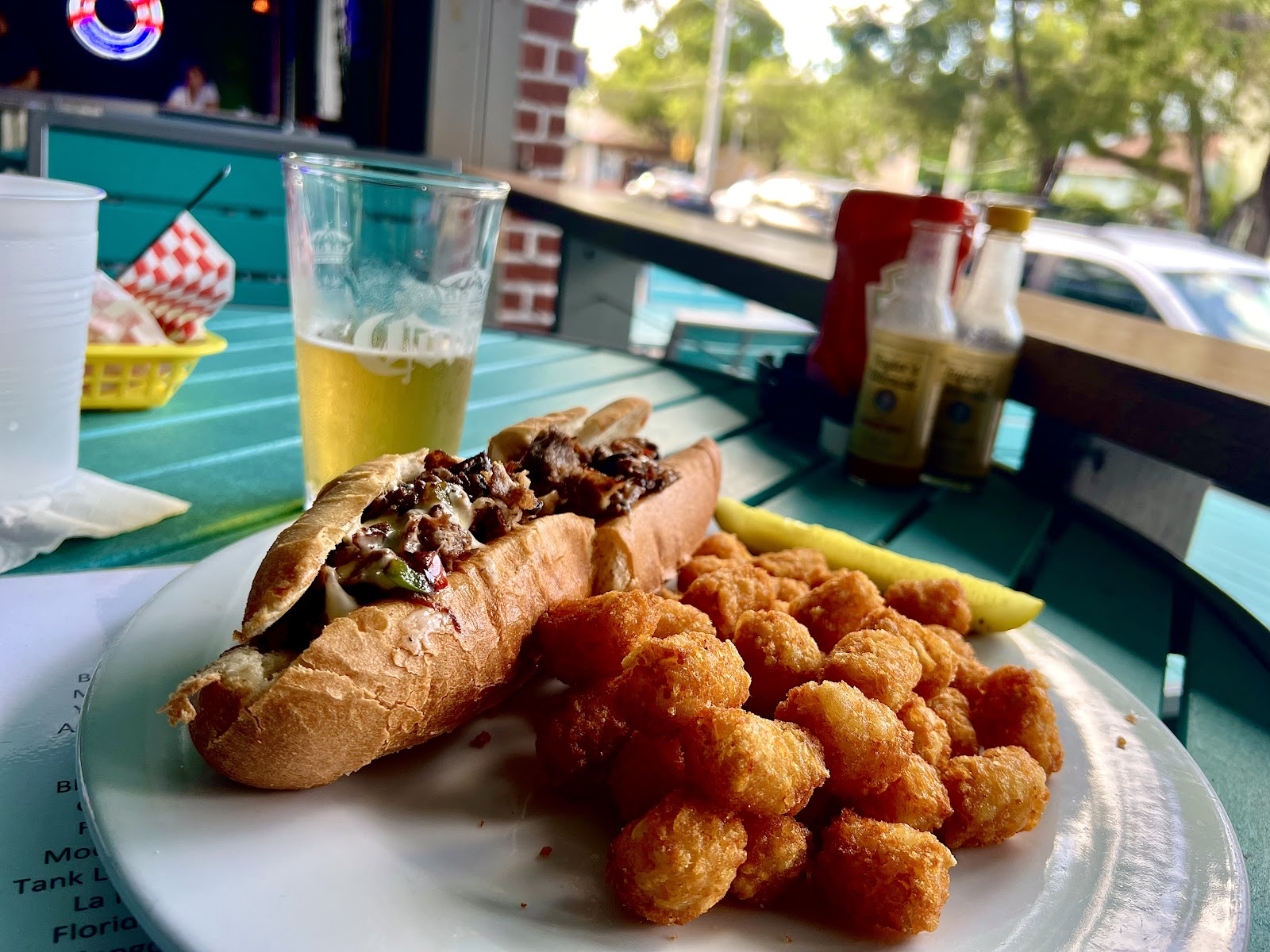 Sandwich and tater tots on table