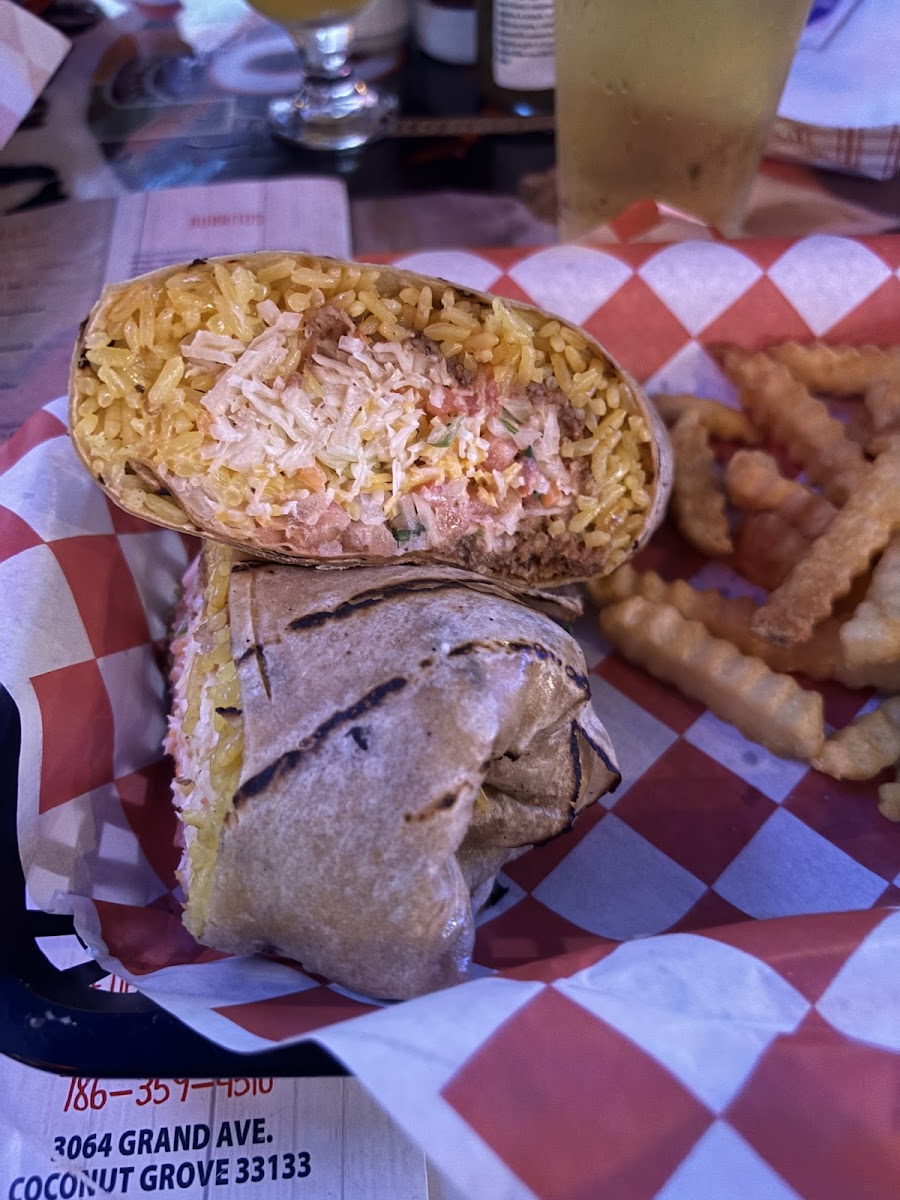 Burrito with fries on checkered paper